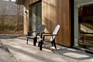 two chairs sitting on a sidewalk outside of a store at Casa Allocco in Norg