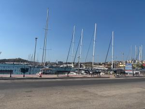 a row of sail boats parked in a marina at NJ Lavrio in Lavrio