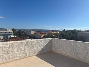 a stone wall with a view of a city at NJ Lavrio in Lavrio