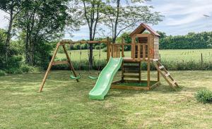 a playground with a slide and a playset at Maison du Figuier 1799 in Nanclars