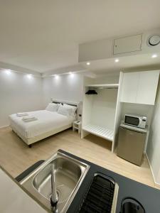 a kitchen with a sink and a bed in a room at ANTONELLA's ROOM in Bresso