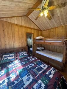 a bedroom with two beds and a ceiling fan at Virginia Creek Settlement in Bridgeport