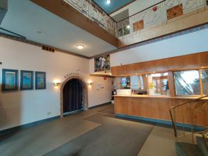 a lobby of a building with a staircase and a counter at Empire Inn in Brandon