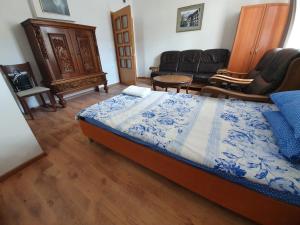 a bedroom with a bed and a living room with furniture at Kennedy House in Lyetnitsa