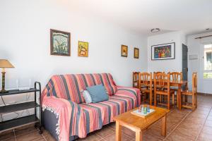 a living room with a couch and a table at Jardín del Golf2 9 1A in Novo Sancti Petri