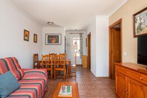 a living room with a couch and a table at Jardín del Golf2 9 1A in Novo Sancti Petri