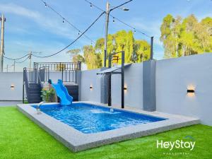a swimming pool with a slide in a yard at MaaiVilla 22Pax4B4B PrivatePool Pooltable BBQ in Gua Sai
