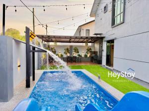 a water feature in the backyard of a house at MaaiVilla 22Pax4B4B PrivatePool Pooltable BBQ in Gua Sai