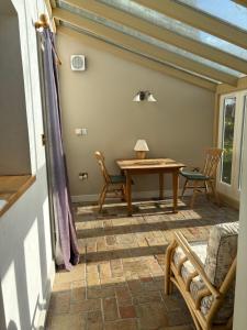 a dining room with a table and chairs on a patio at The Old Post Office, Hilton in Huntingdon