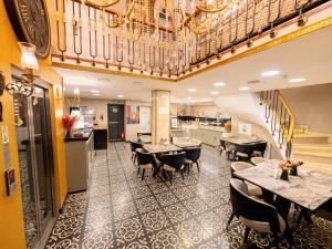 a restaurant with tables and chairs and a staircase at Diamond Royal Hotel in Istanbul