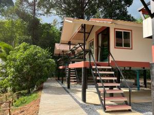 a house with a staircase leading up to it at Wildnest House in Ko Yao Noi