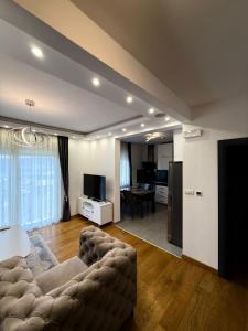 a living room with a couch and a table at Eden apartments in Tivat +44 photos