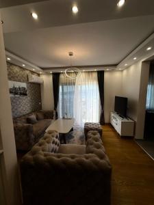a living room with a couch and a table at Eden apartments in Tivat