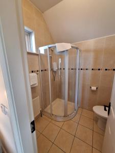 a bathroom with a shower and a sink at Doolin Court in Doolin +79 photos