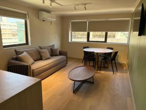 a living room with a couch and a table at RQ Costanera Apartments in Santiago