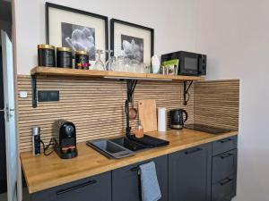 a kitchen with a wooden counter top with a sink at Apartament Wieżyczka in Świdnica