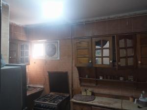 a kitchen with a stove and cabinets and a window at شقة فاخرة موقع ممتاز in Aswan +22 photos