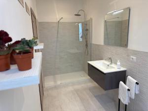 a bathroom with a shower and a sink and a mirror at Villa BRUNI Wine Guest House in Montefalco +47 photos