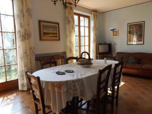 a dining room table with a white table cloth and chairs at Villa Rocca in Marciaga