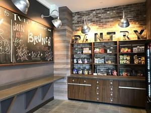 a restaurant with a bar with a menu on the wall at Four Points by Sheraton Midland in Midland