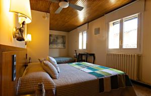 a bedroom with a bed and a ceiling fan at Hostal Victor in Oliana