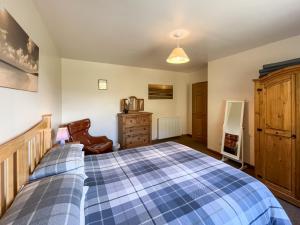 a bedroom with a bed and a dresser at Uk47551 - Cree View Cottage in Newton Stewart +5 photos