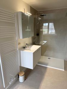 a white bathroom with a sink and a shower at Maison François in Oostkamp +47 photos