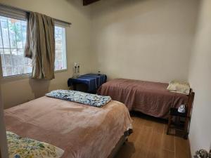 a room with two beds and a window at Casa de Coral in Santa Lucía