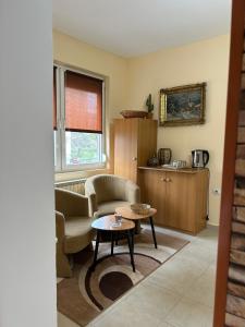a living room with a couch and a table at Guest house Kozle in Skopje