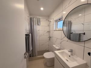 a white bathroom with a sink and a mirror at Dianamar in Albufeira +90 photos