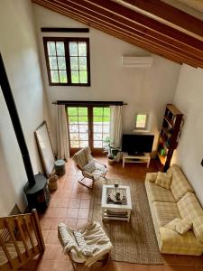a living room with a couch and a fireplace at GITE LA FREYDIERE in La Bégude-de-Mazenc