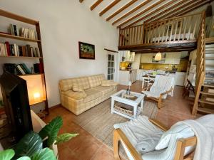 a living room with a couch and a table at GITE LA FREYDIERE in La Bégude-de-Mazenc