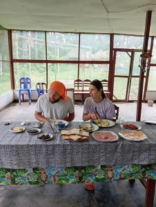 a man and a woman sitting at a table with food at Amazon Macambo Lodge in Iquitos
