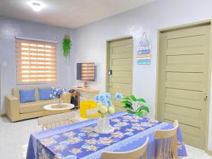 a living room with a table and chairs and a couch at ZK Homestay in Puerto Princesa City