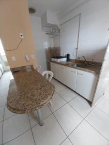 a kitchen with a table and a sink at #Flats Studio 45 Bueno Oeste in Goiânia