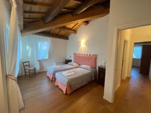 a bedroom with two beds and a wooden ceiling at Villa Ghislanzoni in Vicenza +72 photos