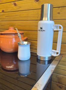 a blender sitting on a table next to a cup at Chalè Aurora do vale in Cobras