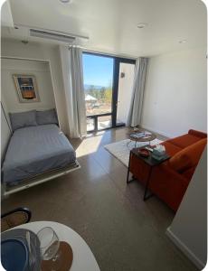 a bedroom with a bed and a couch and a table at Casita in Los Alamos