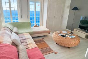 a living room with a couch and a television at Atlantic Views Sintra Guest House in Colares +69 photos
