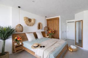 a bedroom with a bed with a hat on it at Anse Marcel Cove Suites in Anse Marcel 