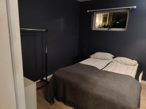 a small bedroom with a bed and a window at Appartement in Harstad 2 in Harstad