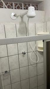a shower with a shower head in a bathroom at Suíte Standard Privado in Vitória +15 photos