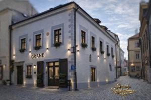 a large white building on a city street at Hotel Grand in Český Krumlov