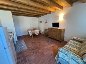 a bedroom with a bed and a desk with a television at Villa Ghislanzoni in Vicenza