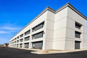 an exterior view of a white building at Spark By Hilton Fort Wayne in Fort Wayne