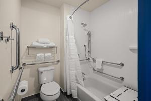 a bathroom with a shower and a toilet and a tub at Spark By Hilton Fort Wayne in Fort Wayne +56 photos