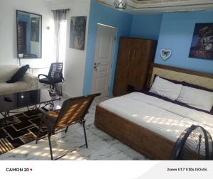 a bedroom with a bed and a table and a desk at RichRoyal Hotels Ltd in Oruama +15 photos