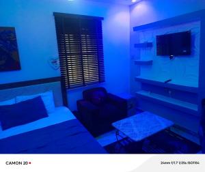 a room with a bed and a couch and a table at RichRoyal Hotels Ltd in Oruama