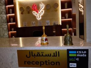 two vases sitting on a counter in a restaurant at فندق الوعل بالخفجى in Khafji