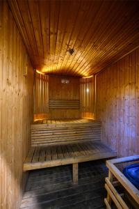 a wooden sauna with a bench in the middle at DoubleTree by Hilton Jeddah - Alandalus Mall in Jeddah +91 photos